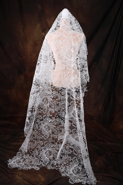 a mannequin wearing a white veil on a black background