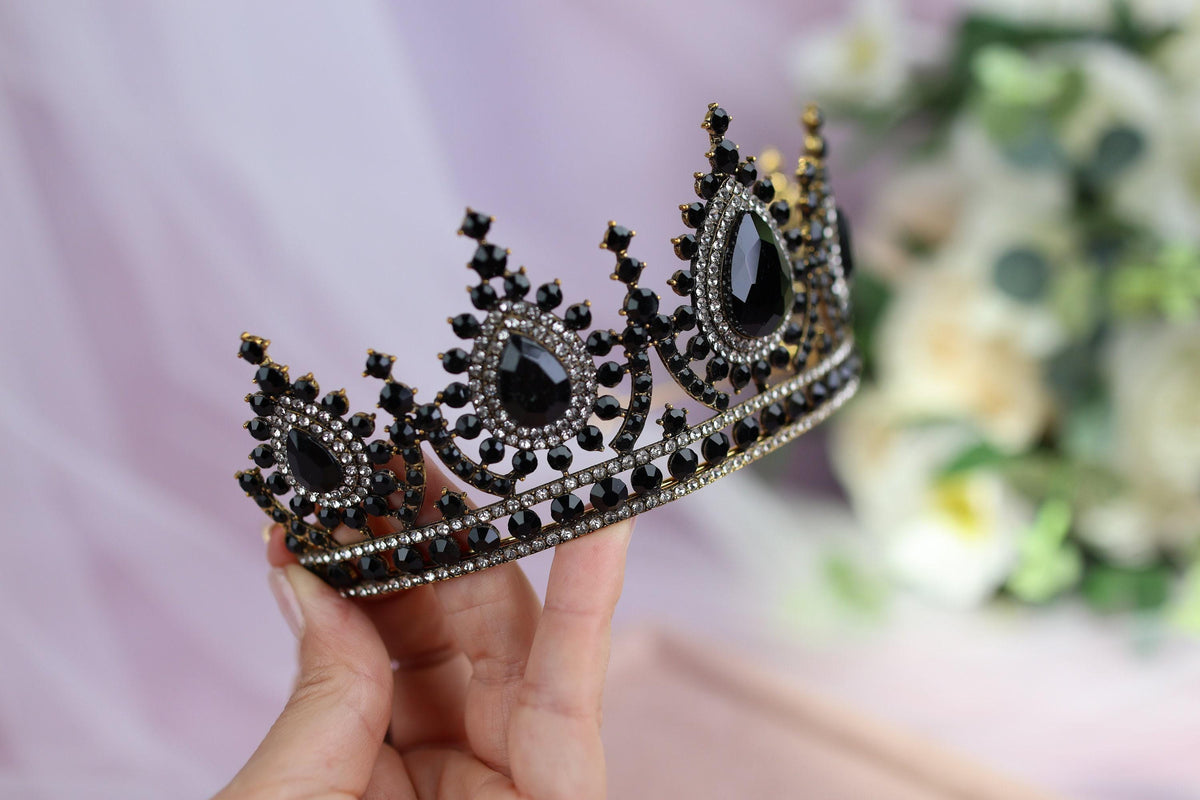 a woman holding a tiara in her hand