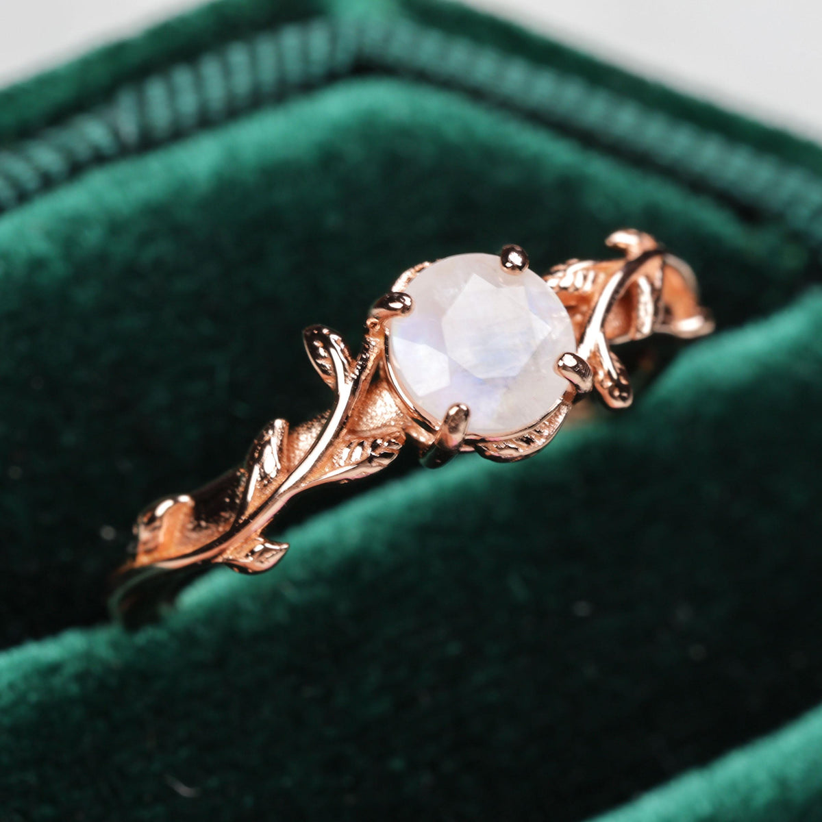 a gold ring with a white stone in it