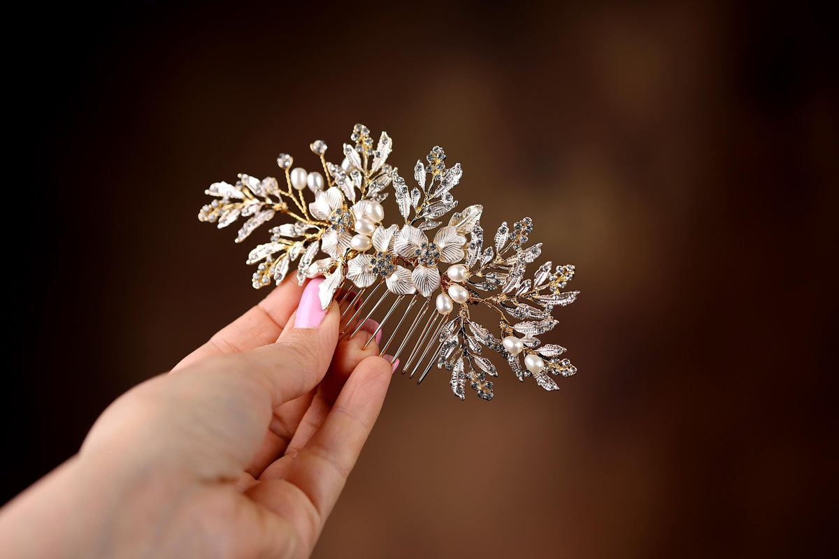 a person holding a hair comb with pearls on it