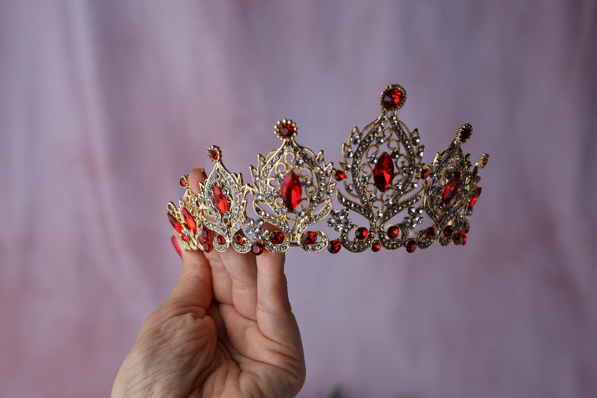 a person holding a piece of jewelry on top of a wooden plate