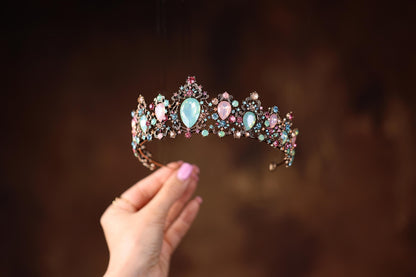 a woman holding a tiara in her hand