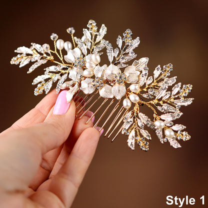 A hand holding a decorative hair accessory with a floral design and sparkling elements.
