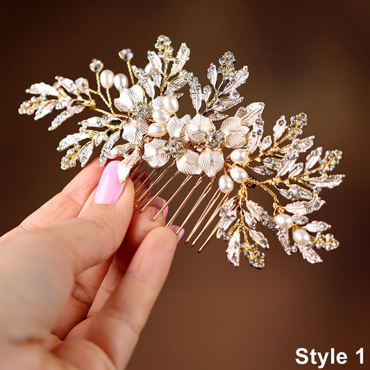 A hand holding a decorative hair accessory with a floral design and sparkling elements.