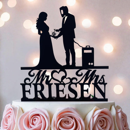 A silhouette of a bride and groom on a wedding cake topper, with the text "Mr. & Mrs. Friesen" below them.