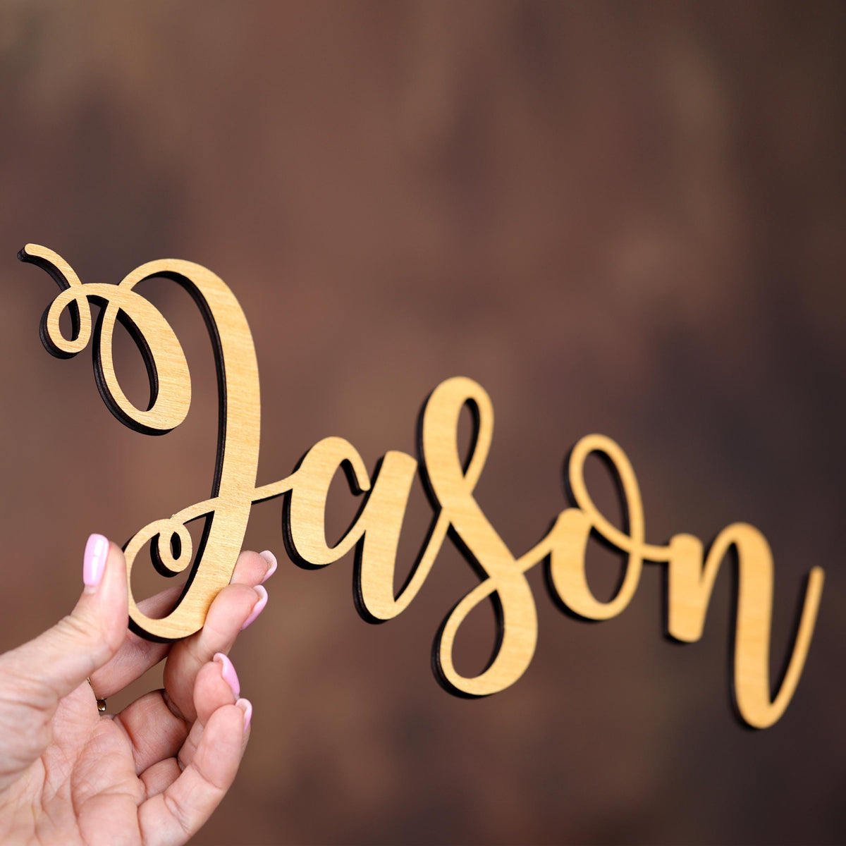 a person holding a piece of wood in their hand