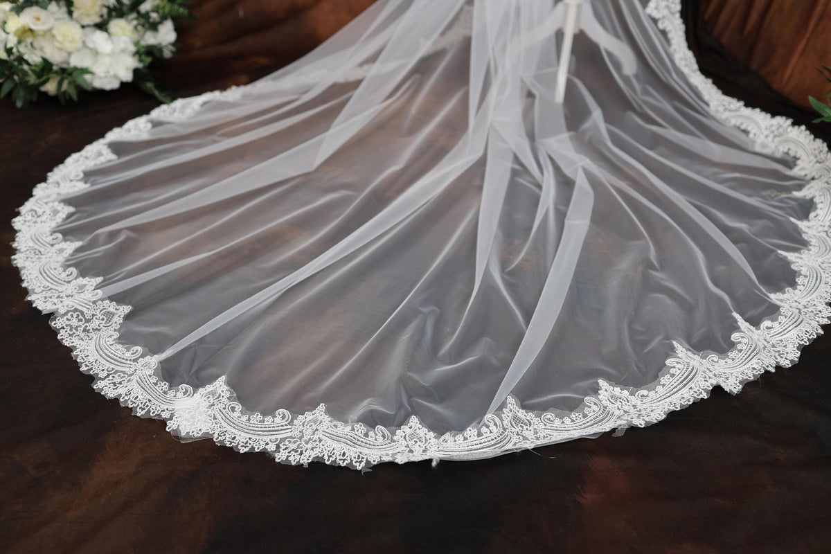 a wedding veil with a flower bouquet in the background