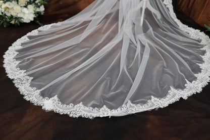 a wedding veil with a flower bouquet in the background