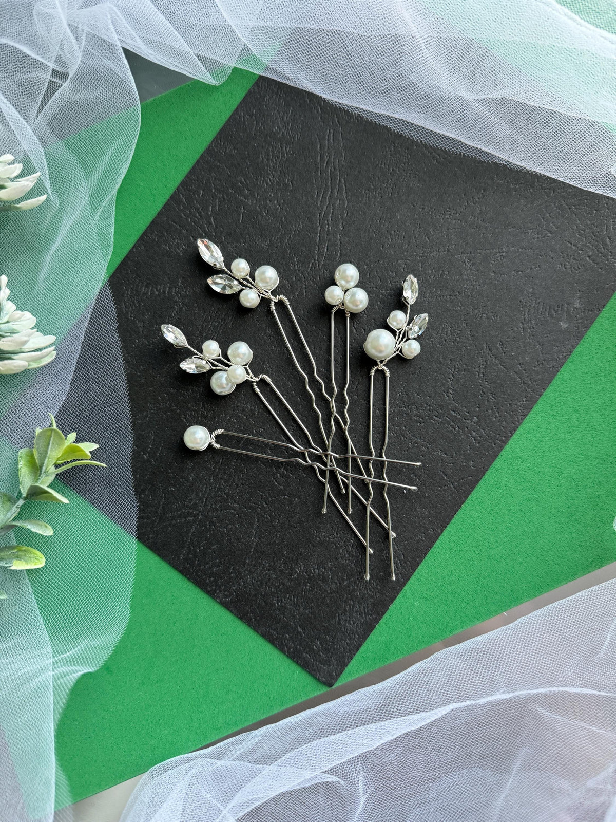 a bunch of pins sitting on top of a piece of paper