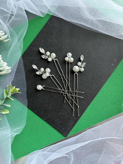 a bunch of pins sitting on top of a piece of paper