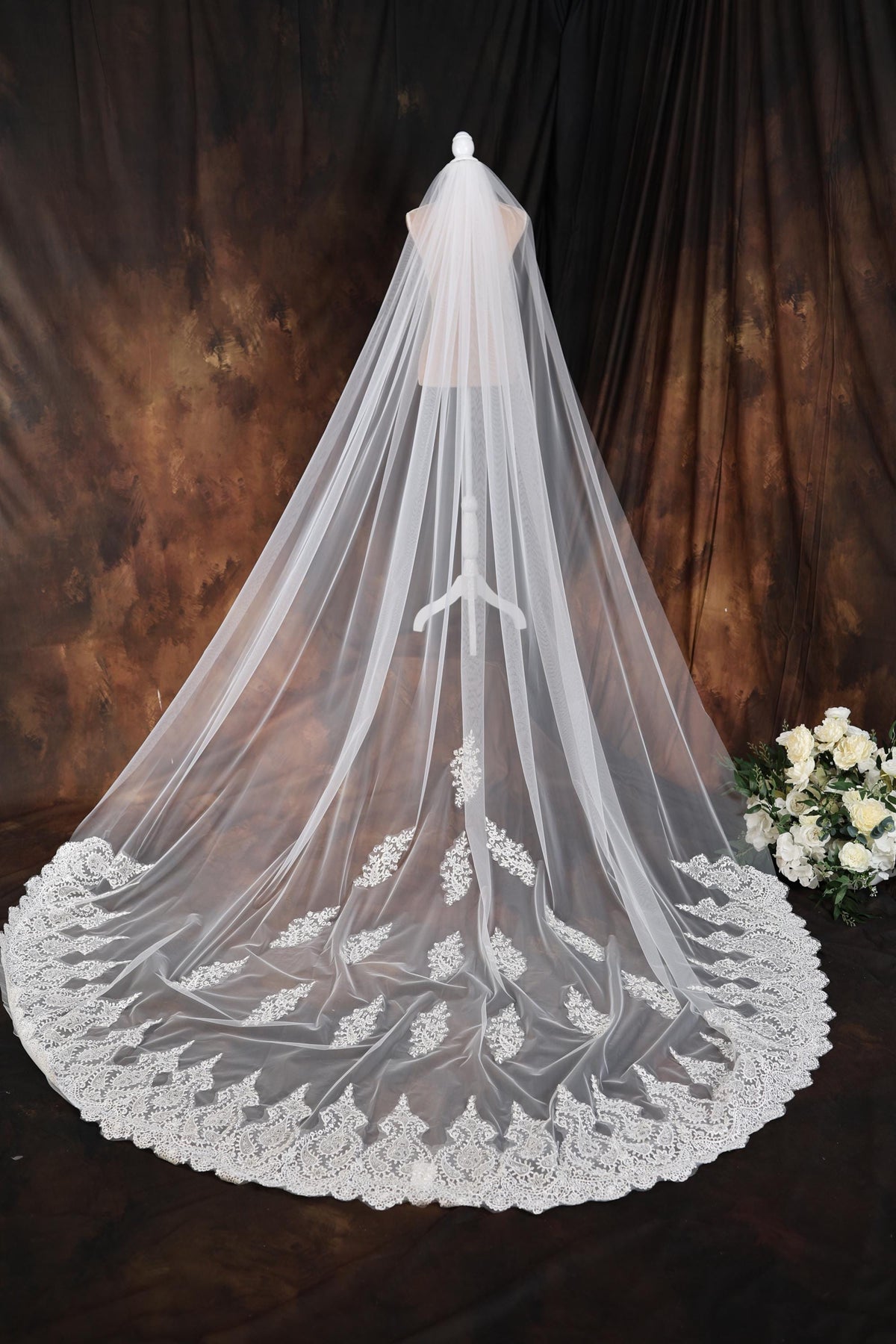 a wedding veil on a table with flowers