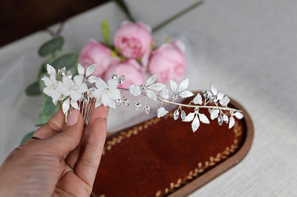 a person holding a flower head piece in their hand