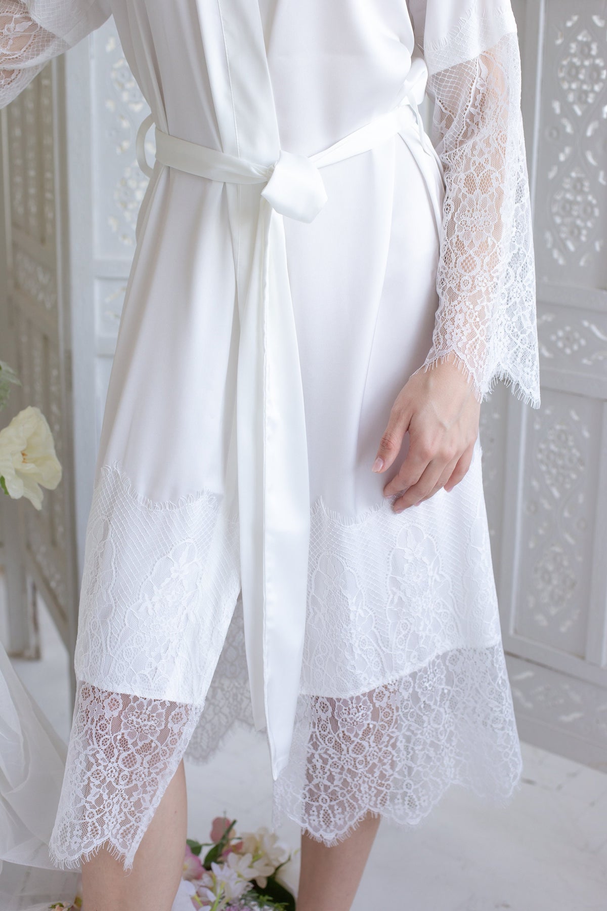 a woman wearing a white robe and high heels