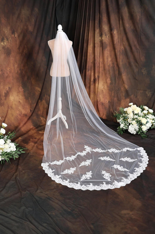 a wedding veil on a mannequin with flowers