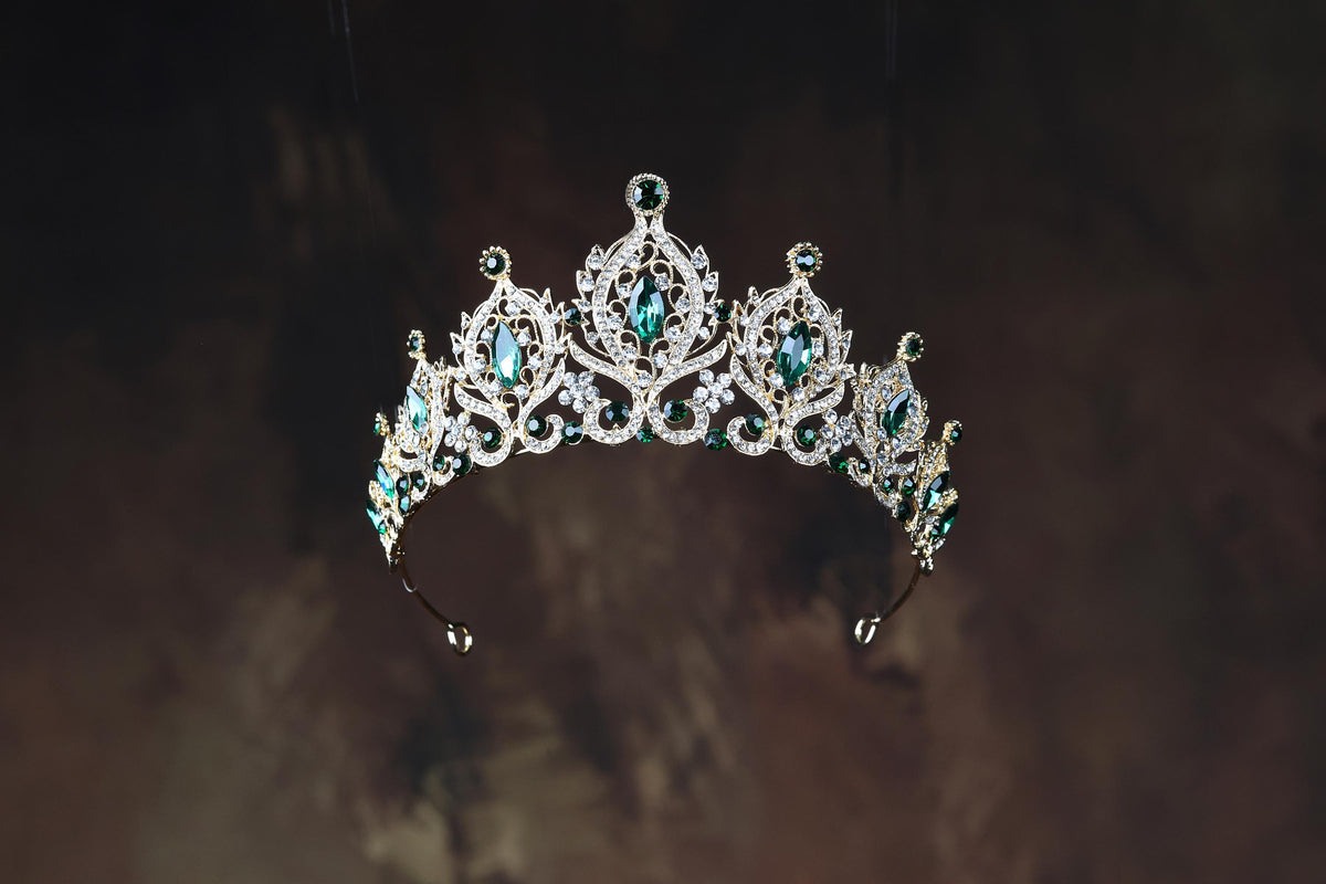 a tiara with green and white stones on it