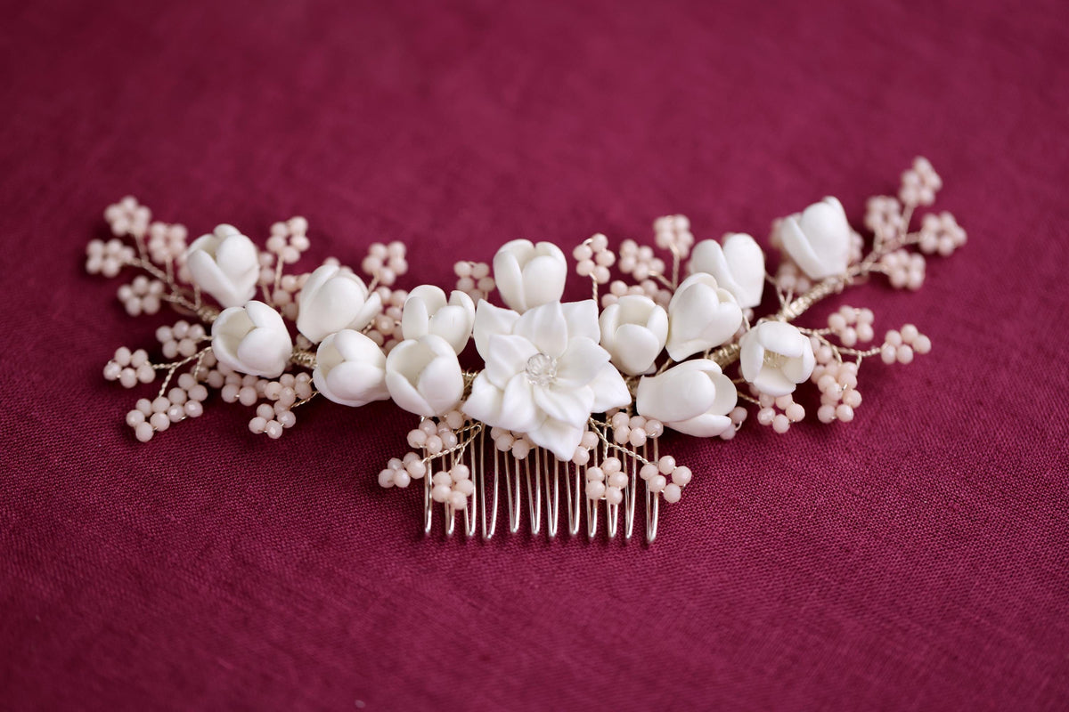 a hair comb with white flowers and pearls