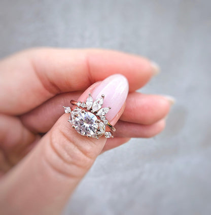 a woman's hand holding a diamond ring
