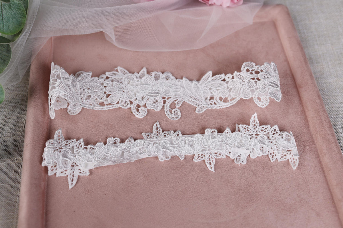 a couple of white garters sitting on top of a pink tray