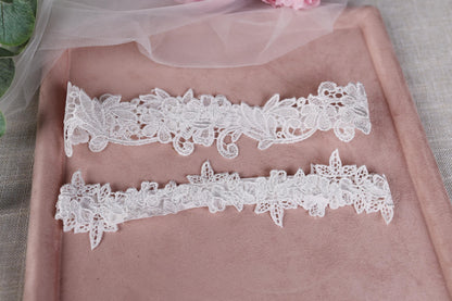 a couple of white garters sitting on top of a pink tray