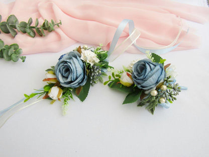 two boutons of blue and white flowers on a white surface