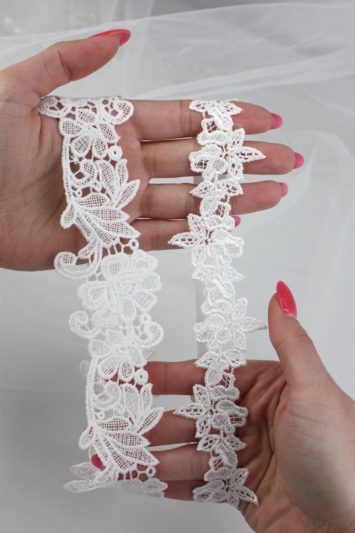 a woman's hands holding a piece of white lace