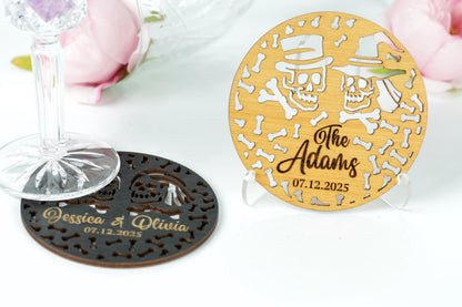 two coasters with personalized names and dates, placed on a white surface.