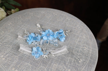 three blue flowers are sitting on top of a table