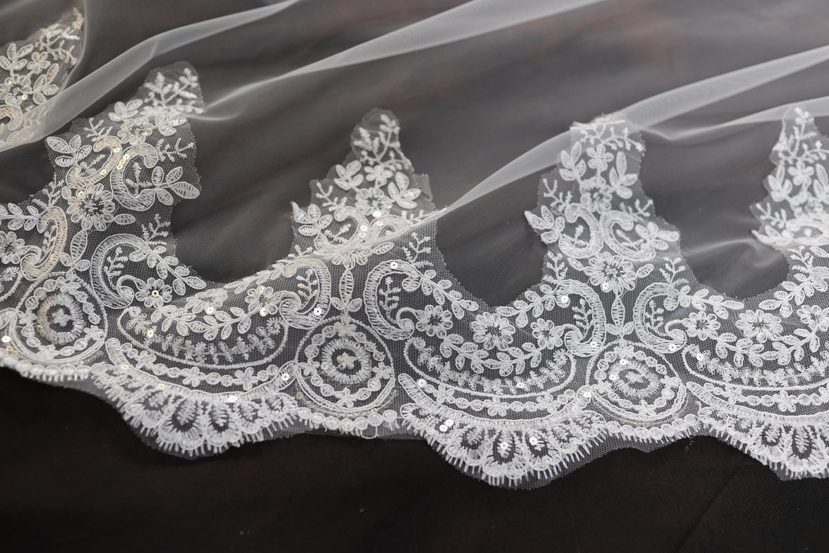 a close up of a wedding veil with white lace