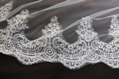 a close up of a wedding veil with white lace