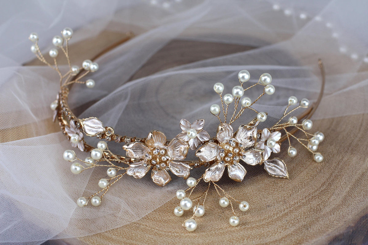 a close up of a tiara with pearls