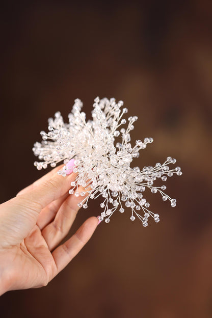 a person holding a small white flower in their hand