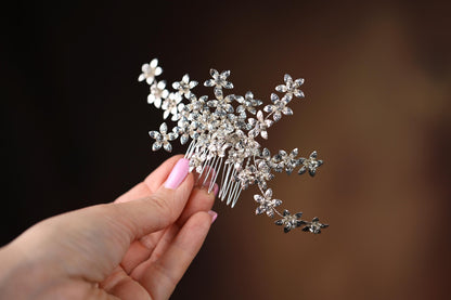 a woman is holding a hair comb in her hand