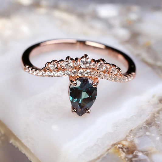 a close up of a ring with a blue stone