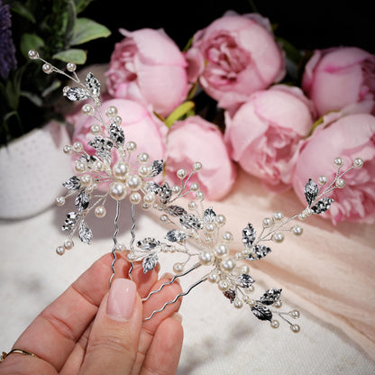 a hand holding a hair comb with flowers in the background