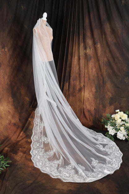 a wedding veil on a mannequin in front of a backdrop