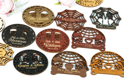 a collection of various wooden coasters or magnets with intricate designs, including a couple of pairs of hearts and a spider web motif.