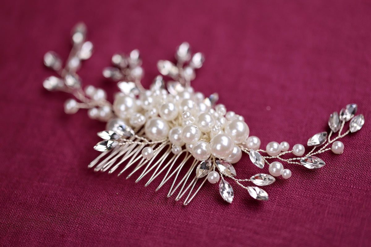 a close up of a hair comb with pearls