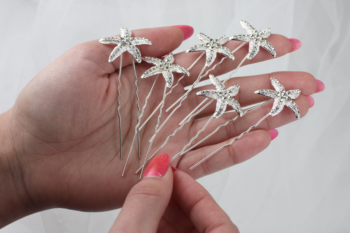 a person holding a bunch of hair pins