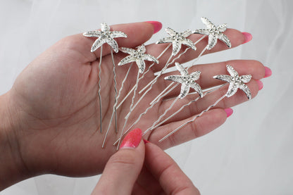 a person holding a bunch of hair pins