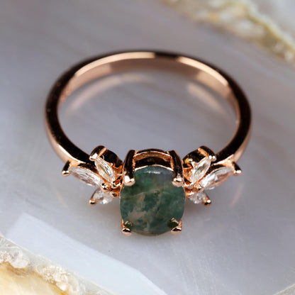 a close up of a ring with a green stone