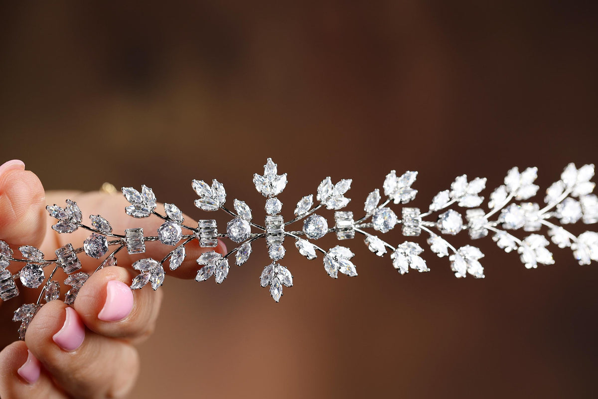 a close up of a person holding a piece of jewelry