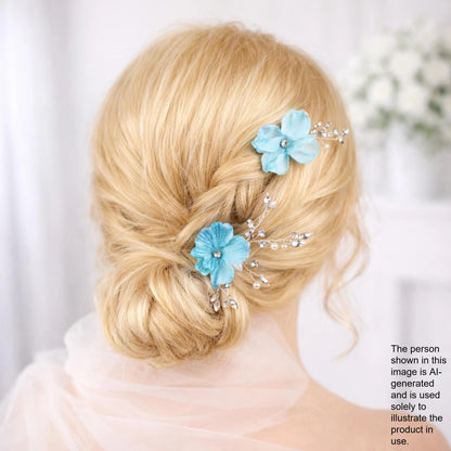 A woman with blonde hair styled in a bun, wearing blue flower hair clips.
