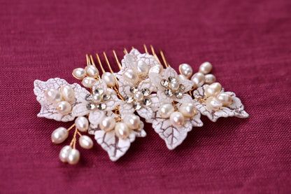 a close up of a hair comb with pearls