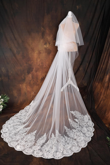 a wedding veil with a lace edge on a mannequin