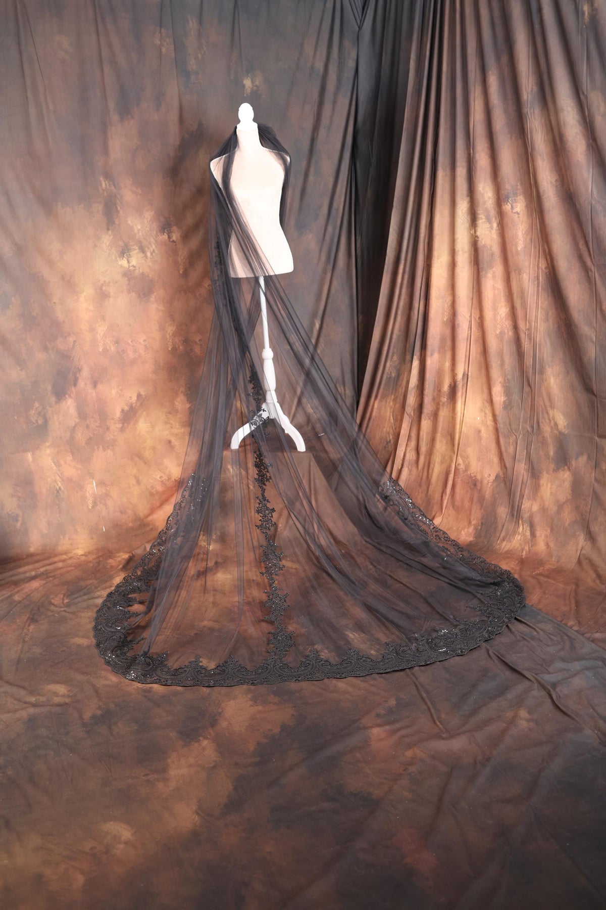 a mannequin's dress on display in front of a curtain