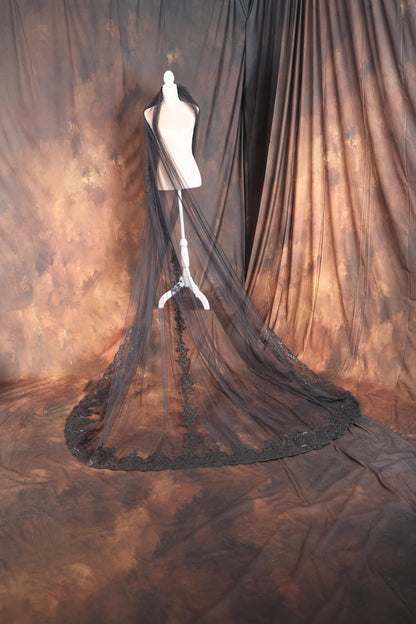 a mannequin's dress on display in front of a curtain