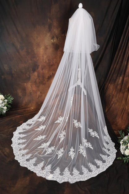 a wedding veil with white flowers on it