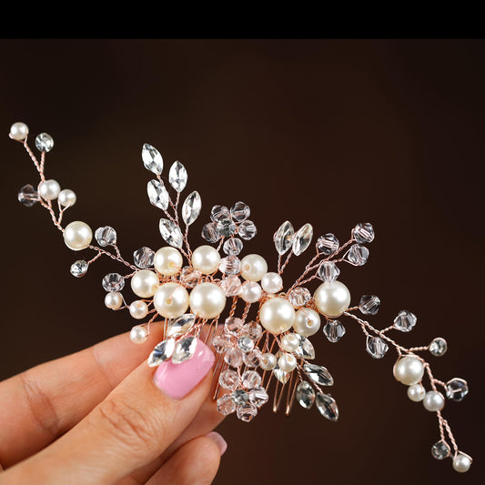 a hand holding a hair comb with pearls and crystals