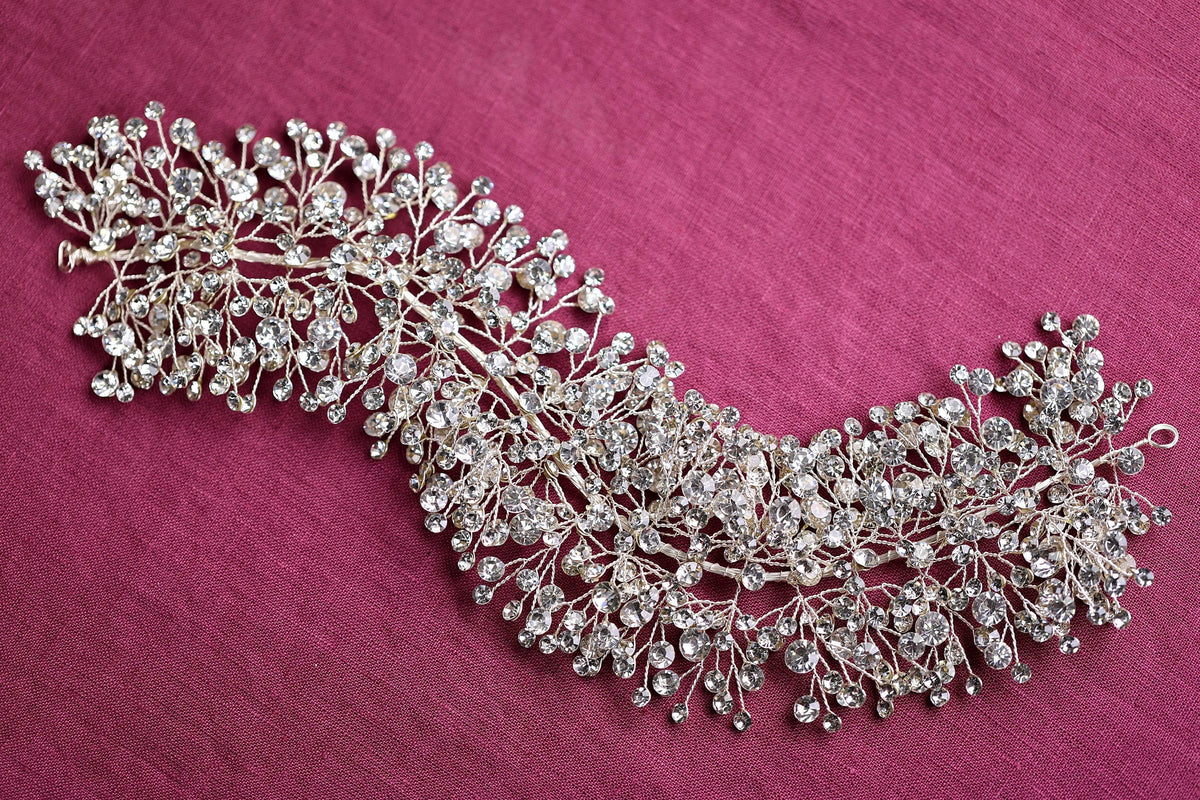 a close up of a brooch on a pink cloth