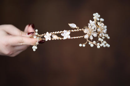 a close up of a person holding a piece of jewelry